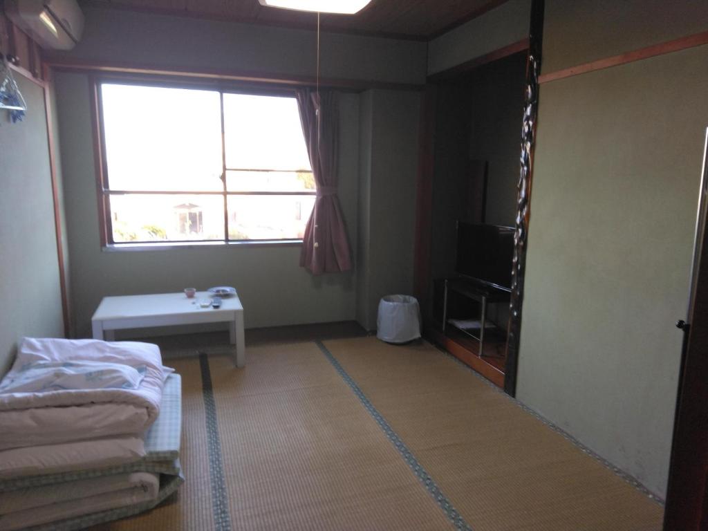 a room with a bed and a window and a table at Ogawaya Ryokan - Vacation STAY 16050v in Tahara