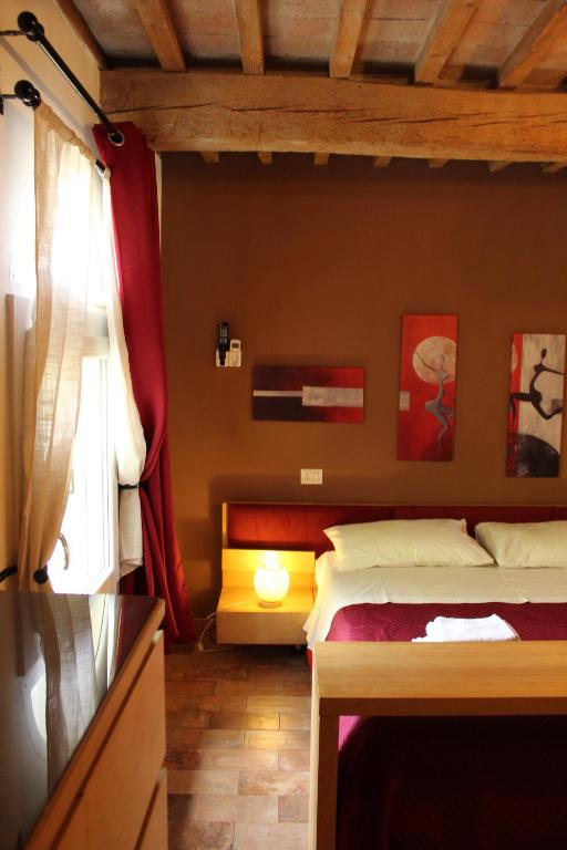 Postel nebo postele na pokoji v ubytování B&B Ca Rossa
