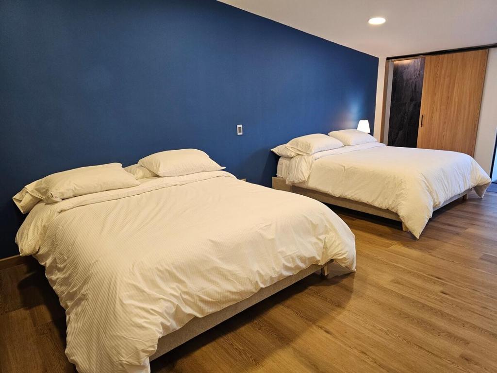 Postel nebo postele na pokoji v ubytování Suite urbana