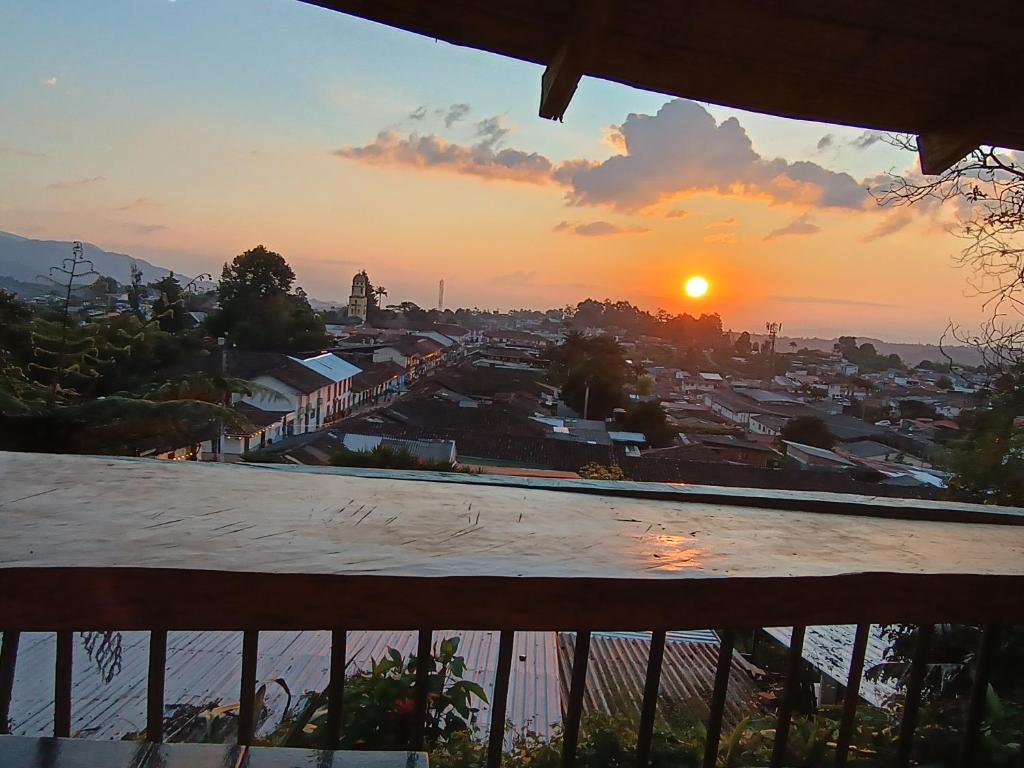 a view of a city at sunset from a balcony at Atardecer De Salento in Salento