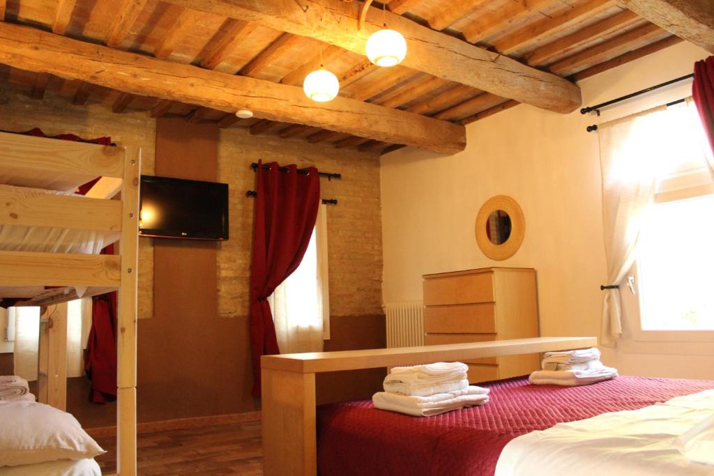 Postel nebo postele na pokoji v ubytování B&B Ca Rossa