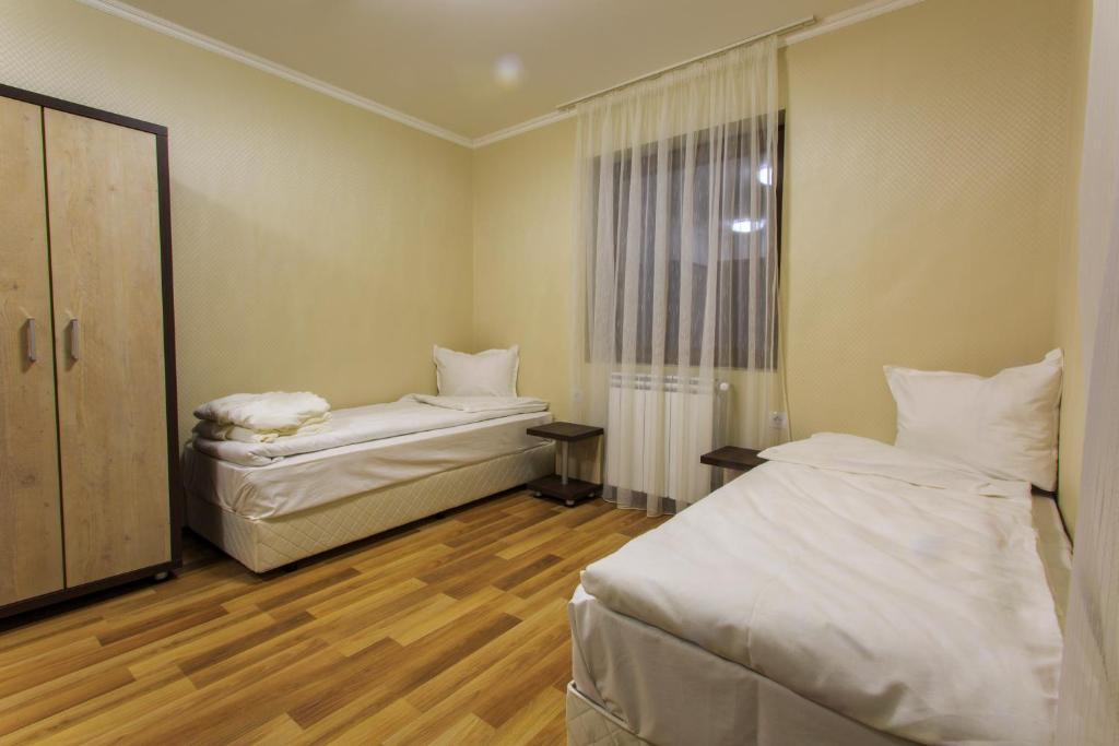 Postel nebo postele na pokoji v ubytování Hotel Nikol