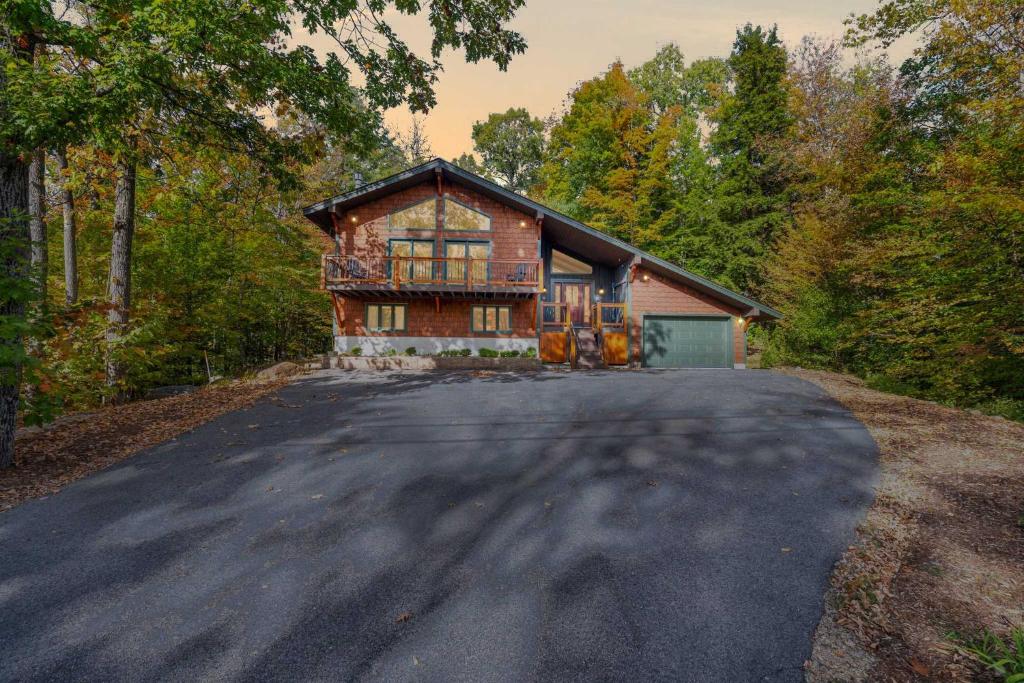 a house with a driveway in front of it at Strasse Ski Chalet Hot Tub Dog-Friendly Skiing in Bartlett