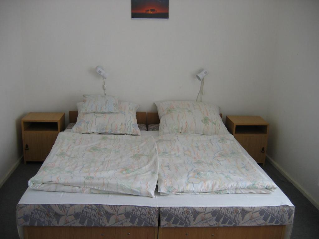 a bed in a room with two twin beds at Barzsó Vendégház in Bogács