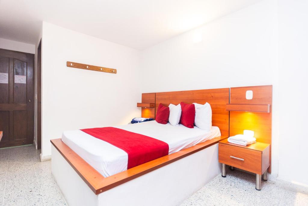 Postel nebo postele na pokoji v ubytování Hotel Bicentenario Rionegro