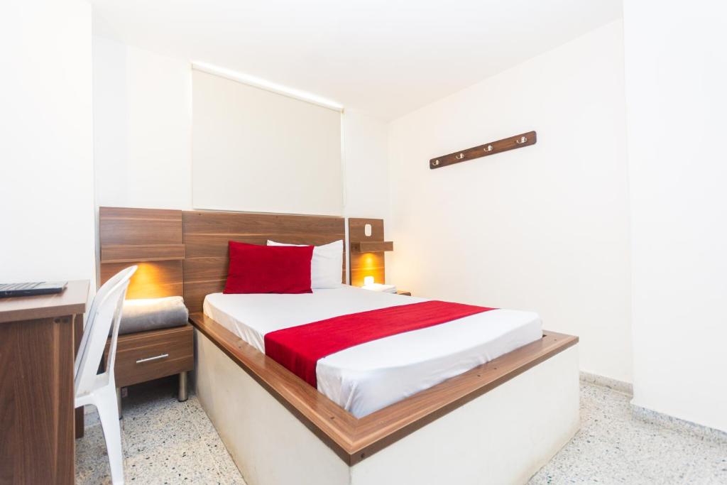 Postel nebo postele na pokoji v ubytování Hotel Bicentenario Rionegro