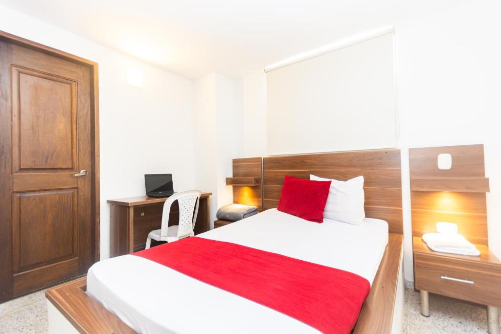 Postel nebo postele na pokoji v ubytování Hotel Bicentenario Rionegro