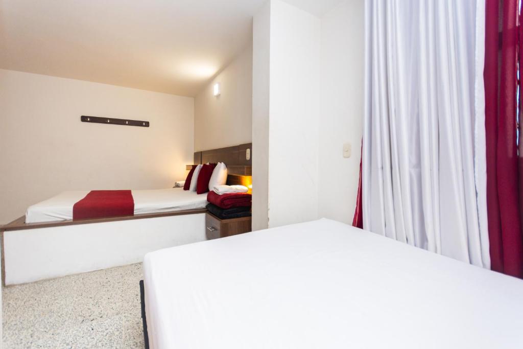 Postel nebo postele na pokoji v ubytování Hotel Bicentenario Rionegro