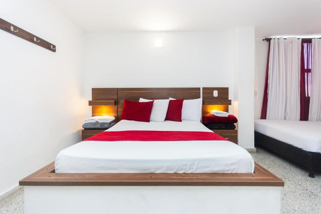 Postel nebo postele na pokoji v ubytování Hotel Bicentenario Rionegro