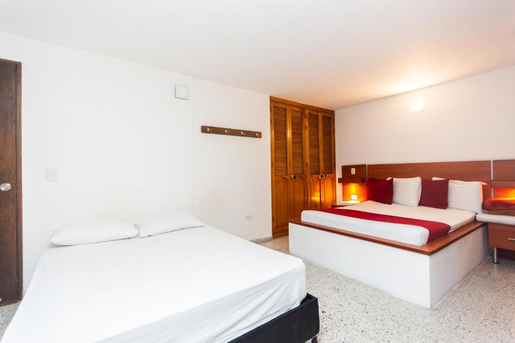 Postel nebo postele na pokoji v ubytování Hotel Bicentenario Rionegro