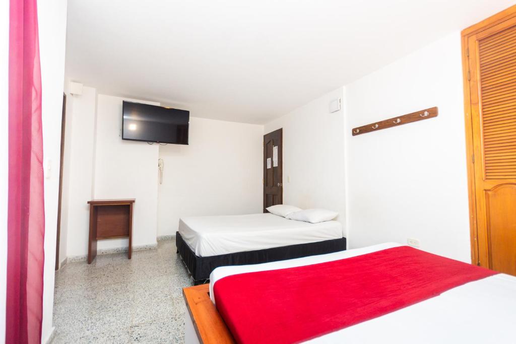 Postel nebo postele na pokoji v ubytování Hotel Bicentenario Rionegro