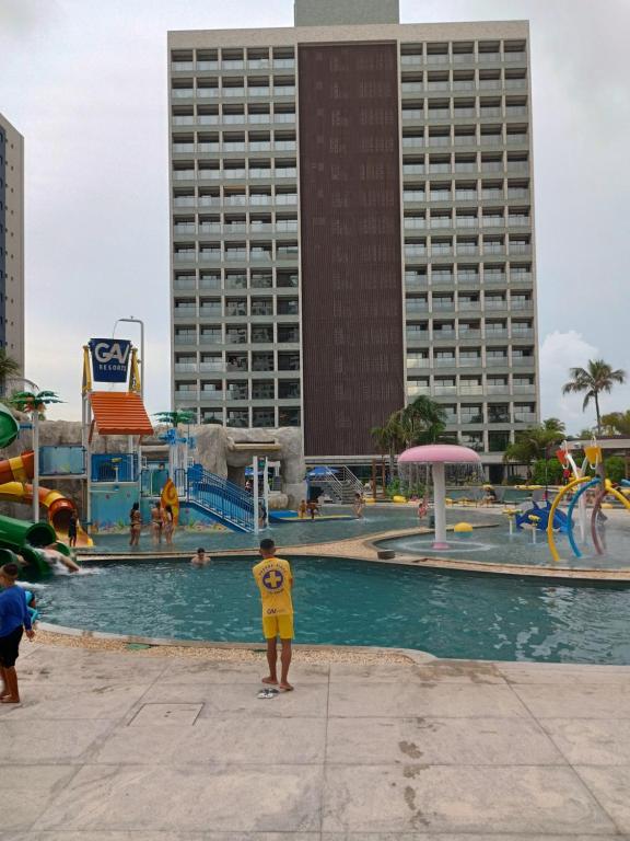 a boy standing in a pool at a water park at Salinas Premium Resort in Salinópolis