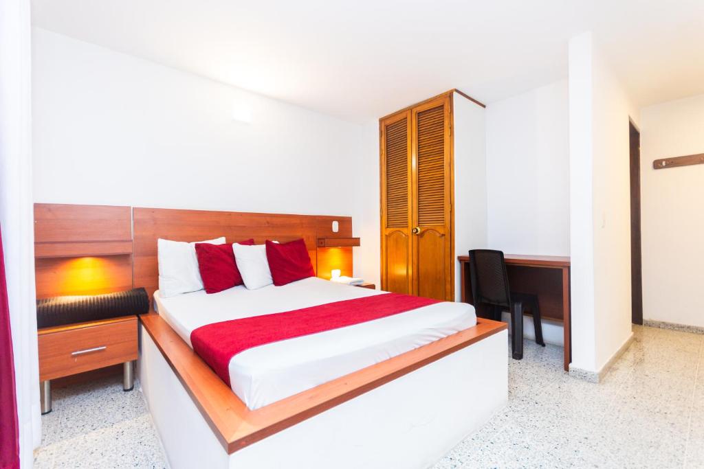 Postel nebo postele na pokoji v ubytování Hotel Bicentenario Rionegro