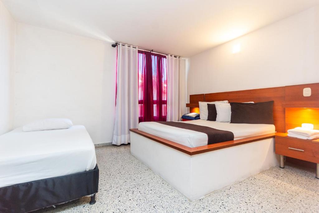 Postel nebo postele na pokoji v ubytování Hotel Bicentenario Rionegro