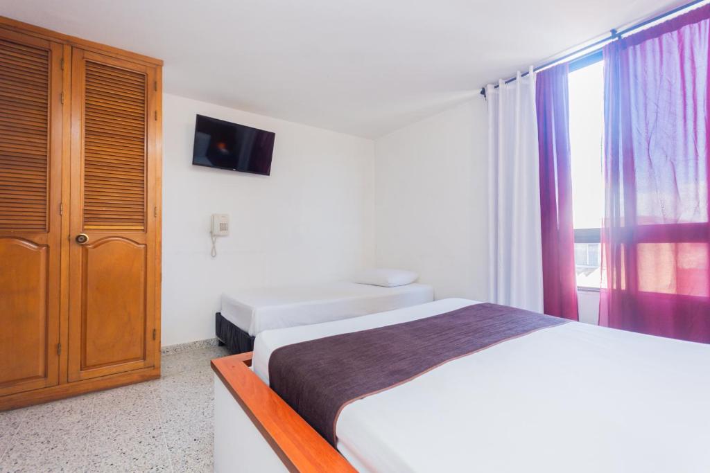 Postel nebo postele na pokoji v ubytování Hotel Bicentenario Rionegro