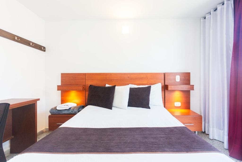 Postel nebo postele na pokoji v ubytování Hotel Bicentenario Rionegro