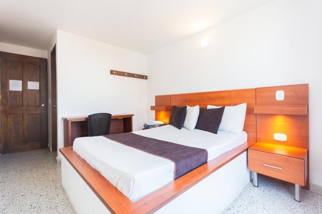 Postel nebo postele na pokoji v ubytování Hotel Bicentenario Rionegro