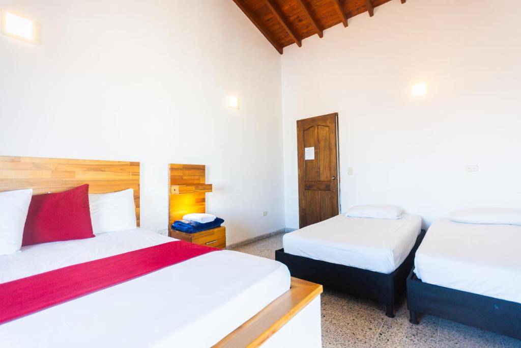 Postel nebo postele na pokoji v ubytování Hotel Bicentenario Rionegro