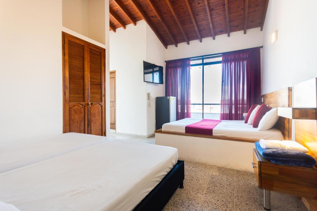 Postel nebo postele na pokoji v ubytování Hotel Bicentenario Rionegro