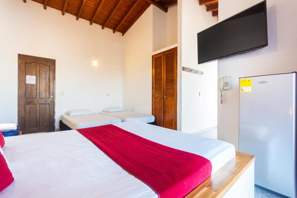 Postel nebo postele na pokoji v ubytování Hotel Bicentenario Rionegro