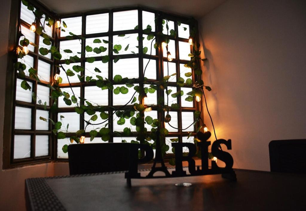 una mesa de comedor con una ventana con una planta en Casa cerca de concierto Marc Anthony Med Plus, en Bogotá