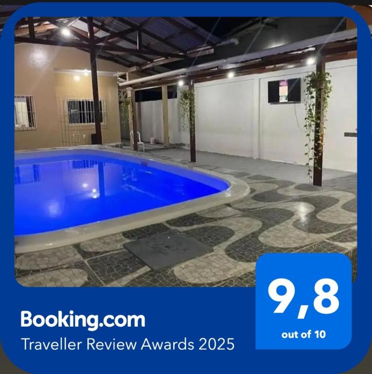 a large blue swimming pool in a building at casa de praia in Macapá