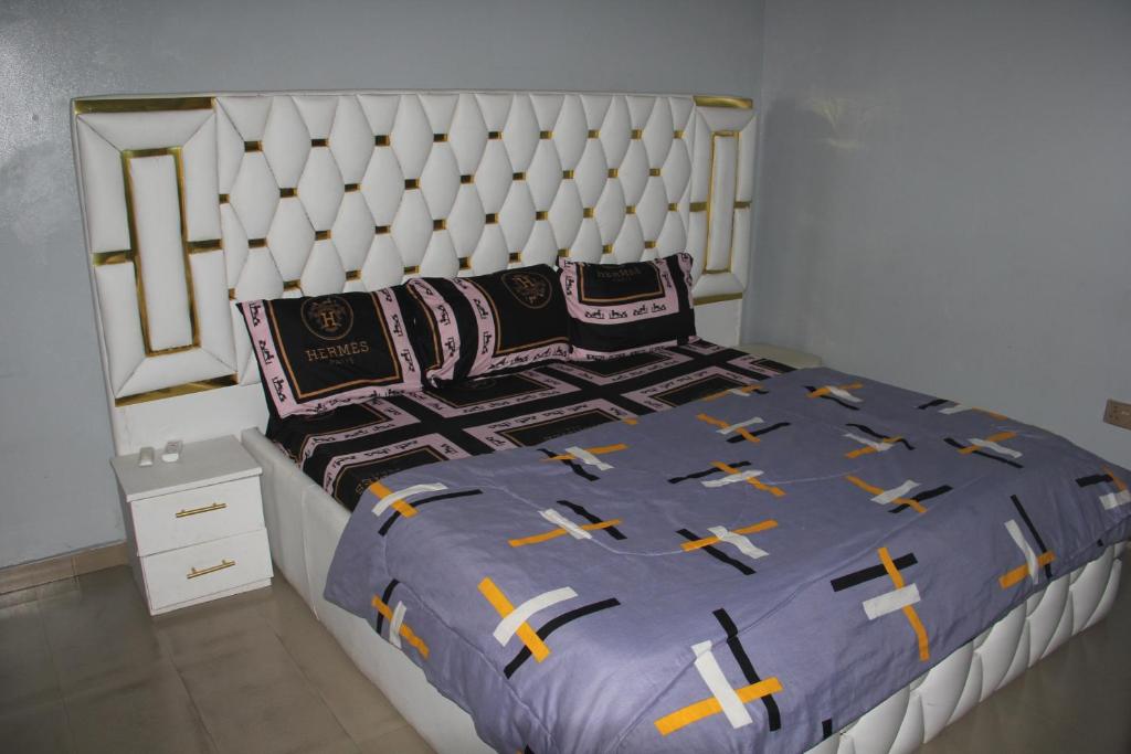 a bedroom with a large bed with a white headboard at London touch great 2bedroom with free WiFi 24hr light N65,000 in Port Harcourt
