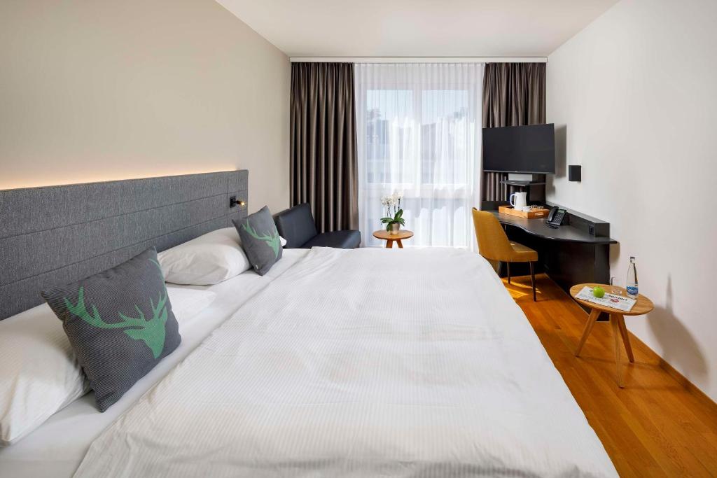 Postel nebo postele na pokoji v ubytování Hotel Allegra Lodge