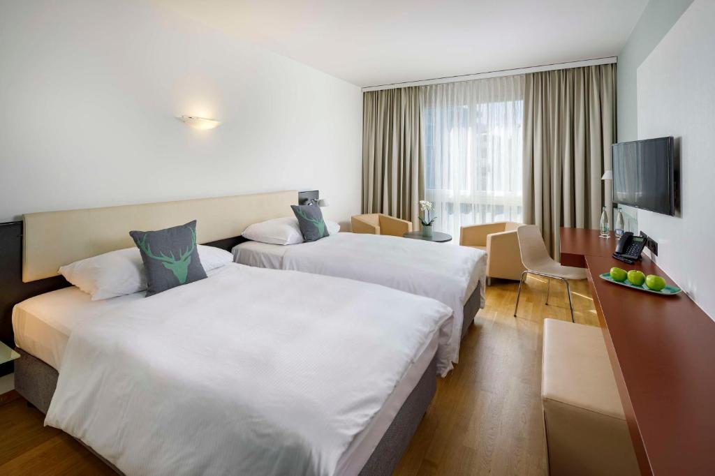 Postel nebo postele na pokoji v ubytování Hotel Allegra Lodge