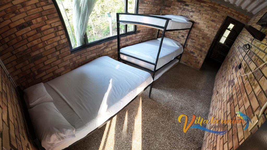 Postel nebo postele na pokoji v ubytování Finca Campestre Villa La Unión Hotel en Mesitas