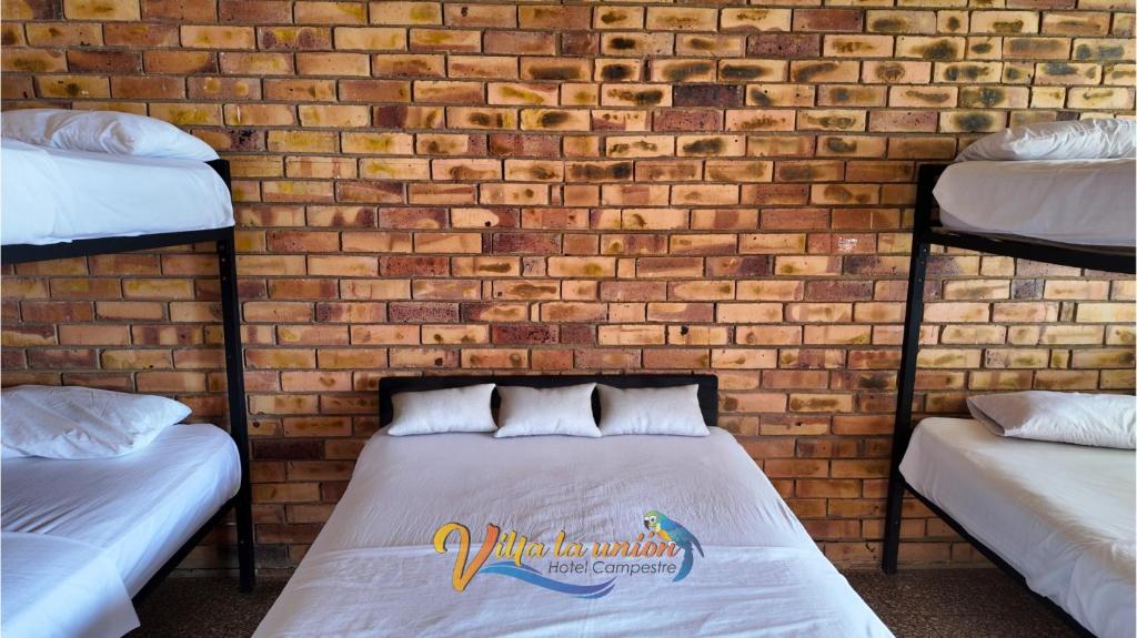 Postel nebo postele na pokoji v ubytování Finca Campestre Villa La Unión Hotel en Mesitas