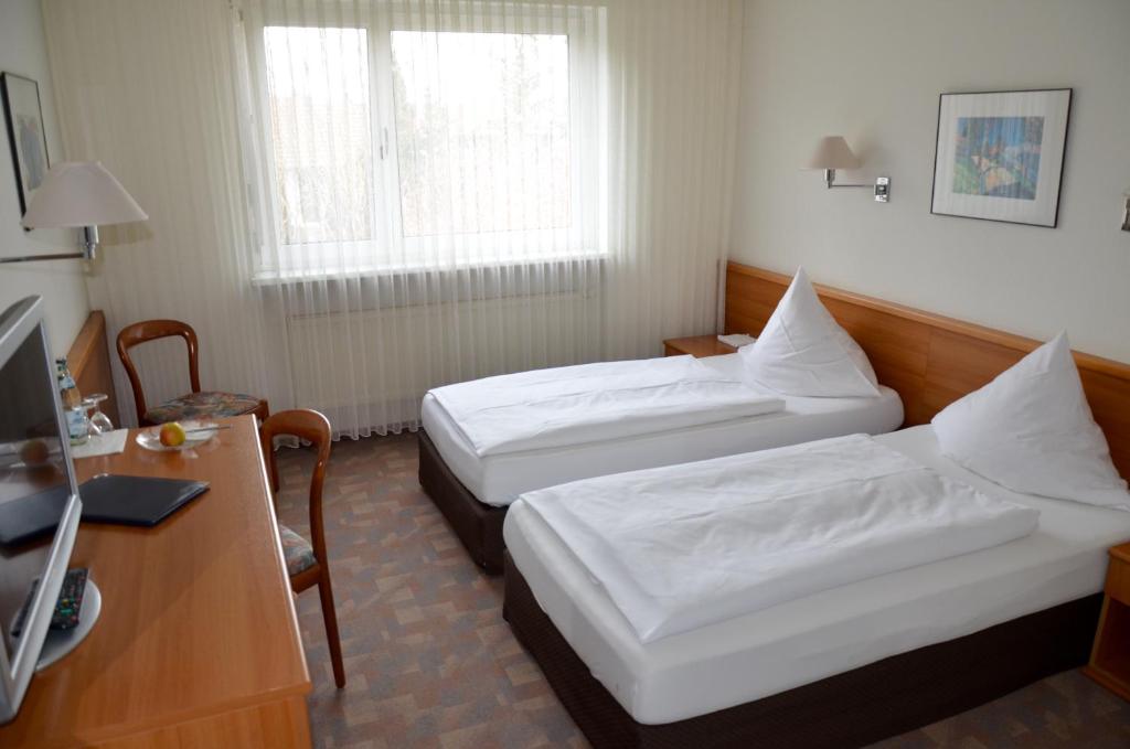 Postel nebo postele na pokoji v ubytování Hotel Höllsteiner Hof