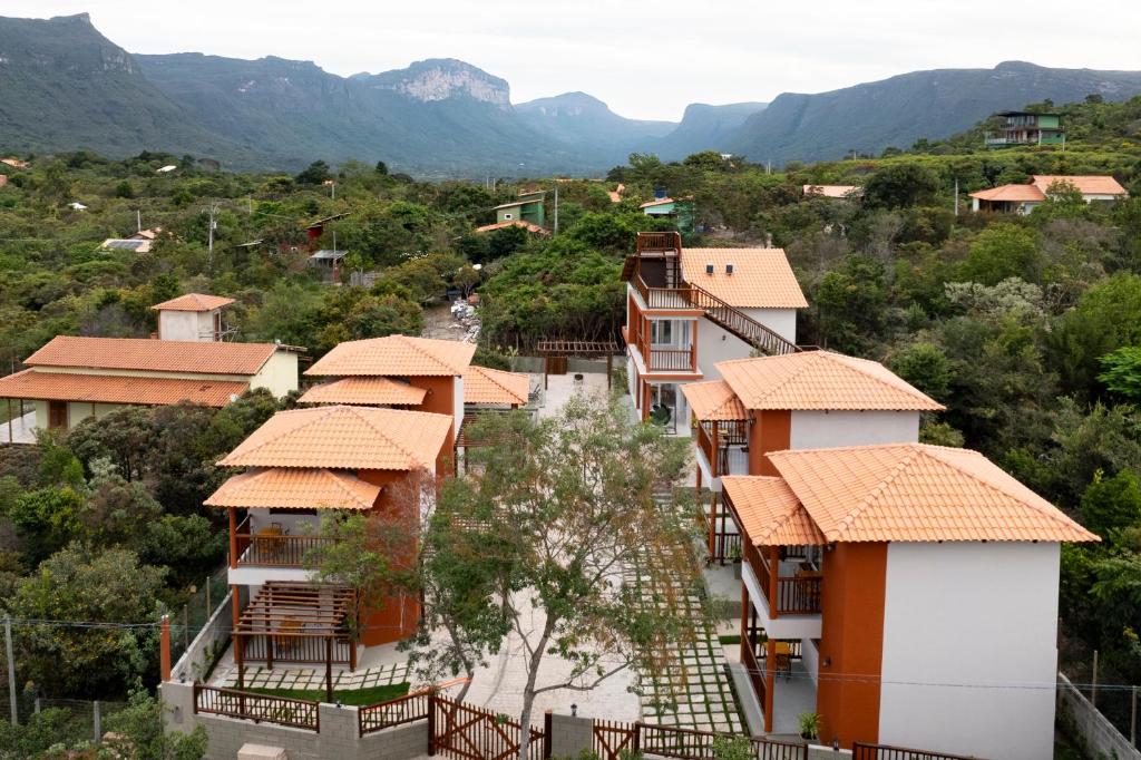 a group of houses with mountains in the background at Bangalôs da chapad in Vale do Capao