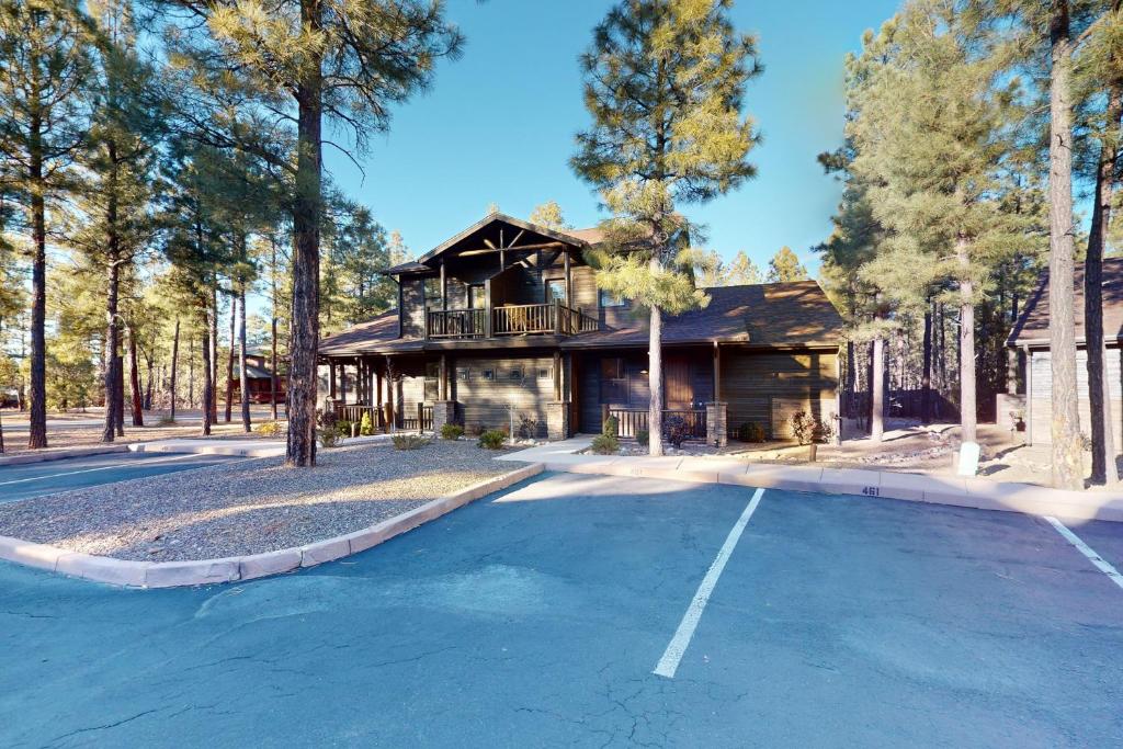 a house in the woods with a parking lot at Mountain View Retreat in Show Low