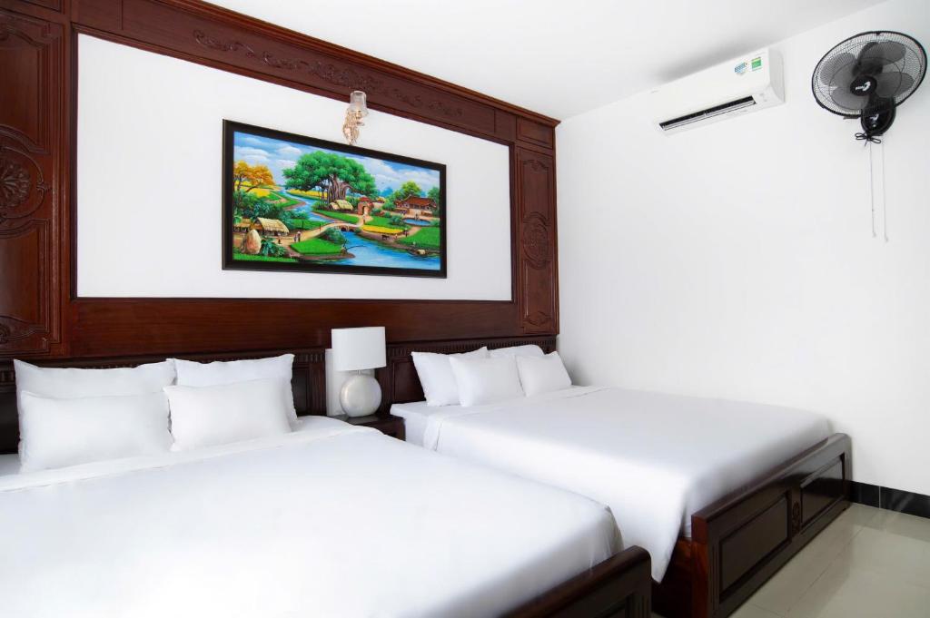 Postel nebo postele na pokoji v ubytování Horizon Côn Đảo Hotel