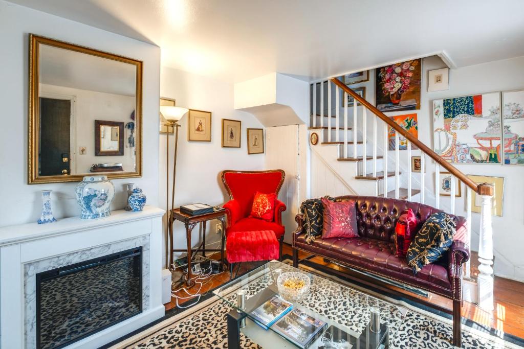 a living room with a fireplace and a red couch at 1 Mi to Old Town Historic Area Gem in Alexandria in Alexandria