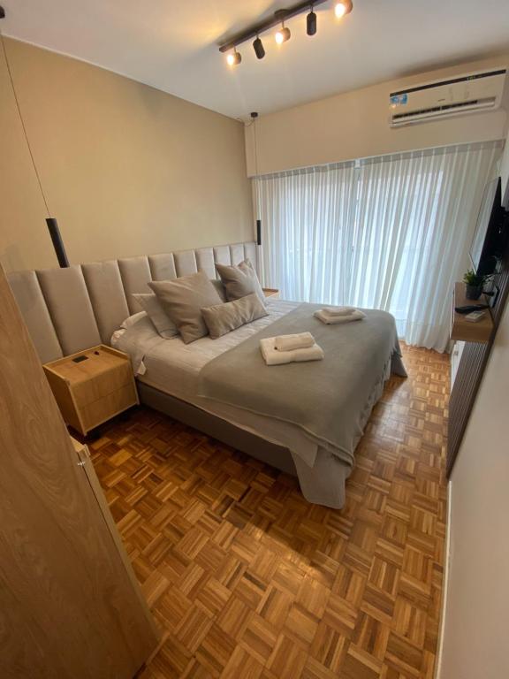a bedroom with a bed with two towels on it at Welcome to Buenos Aires in Buenos Aires