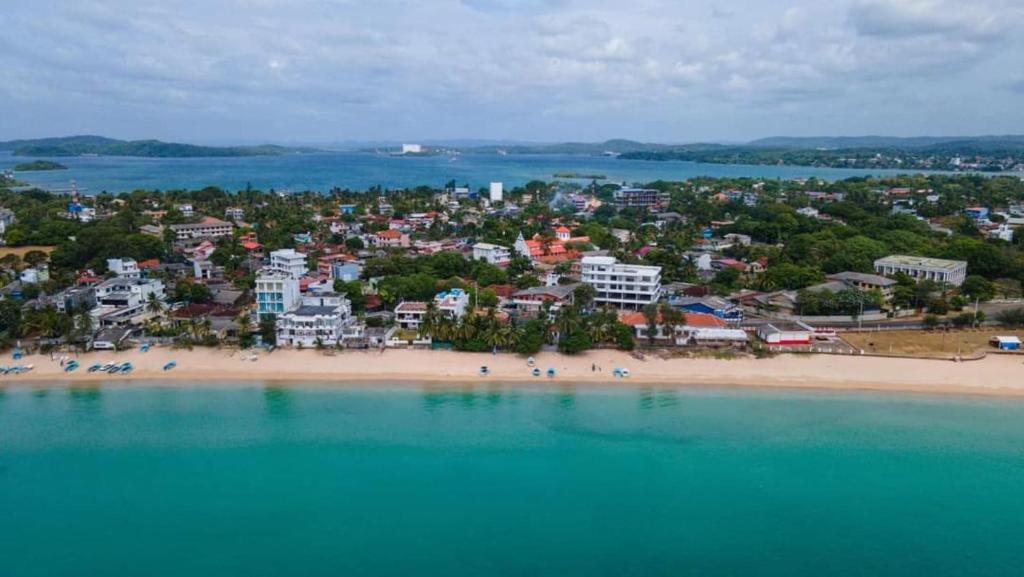 an aerial view of a beach with people on it at Blackpool Complex - Lavender in Trincomalee