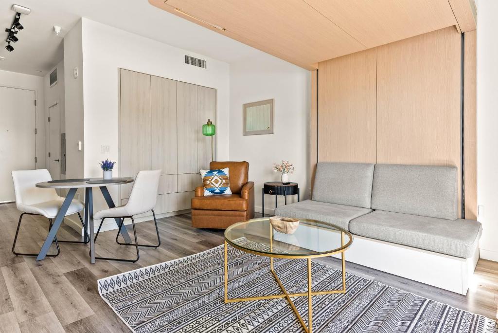 a living room with a couch and a table at Modern Hollywood Studio, Pool Parking Gym in Los Angeles