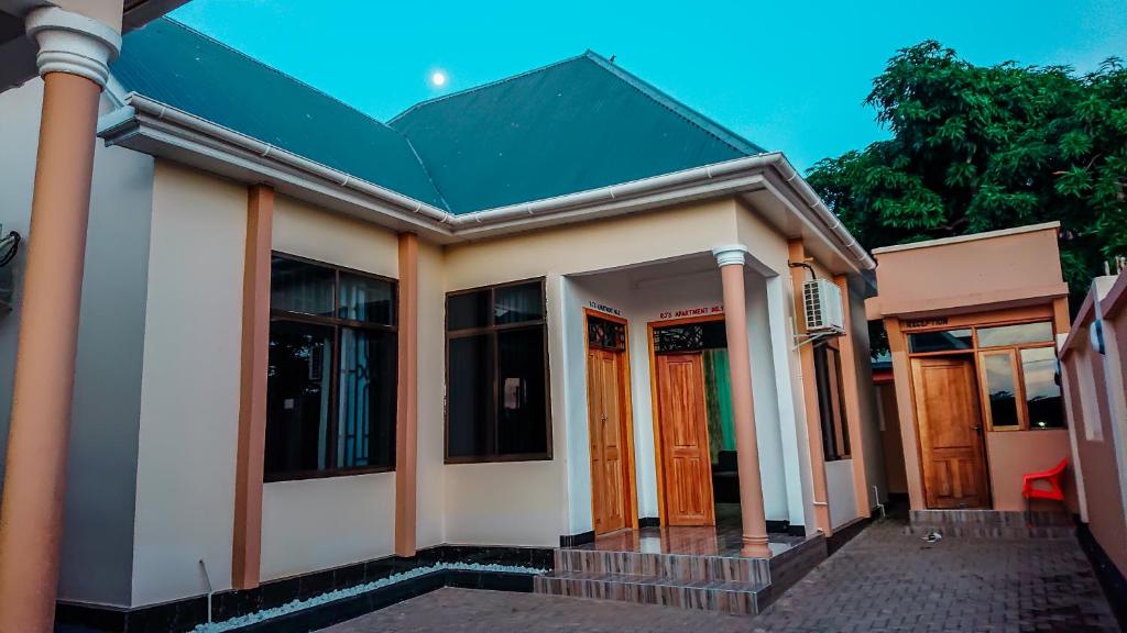 a small house with a green roof at RJ's Apartments Korogwe in Korogwe