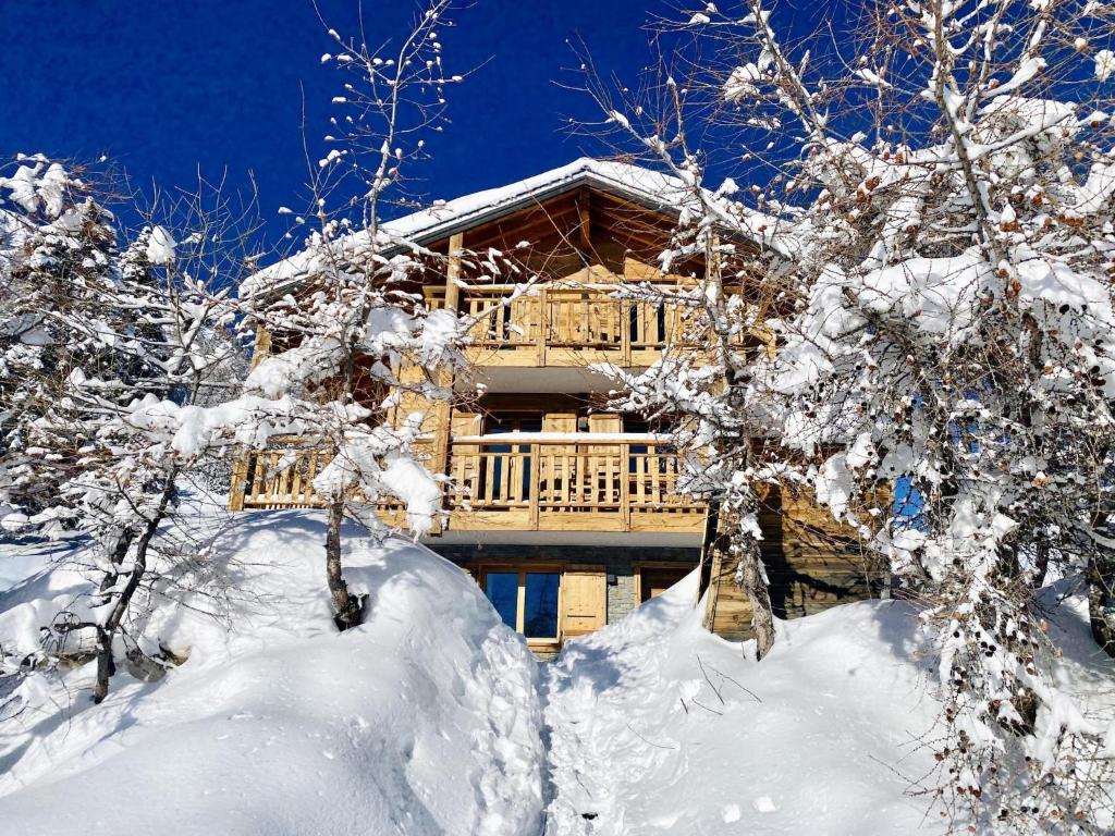 a log cabin in the snow with snow covered trees at Chalet in 4 Vallées with Ski-In Access in Les Collons