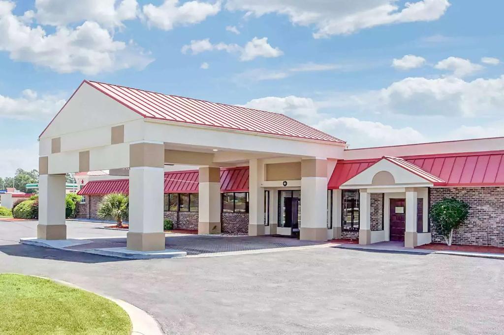 a large building with a red roof at Ramada by Wyndham Santee I-95 in Santee
