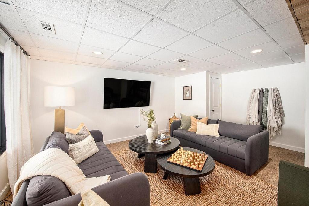 a living room with a couch and a table at New Beach front 5bd in Sister Lakes with Hot tub in Dowagiac