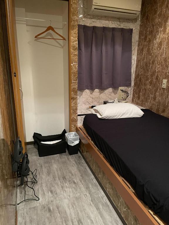 Postel nebo postele na pokoji v ubytování ホテル サンガ