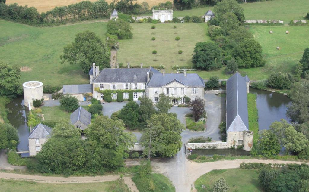 an aerial view of a large house with a river at Chateau de Vouilly in Vouilly