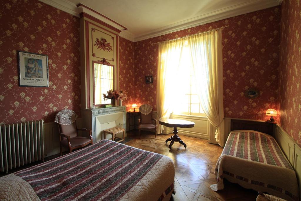 Postel nebo postele na pokoji v ubytování Chateau de Vouilly