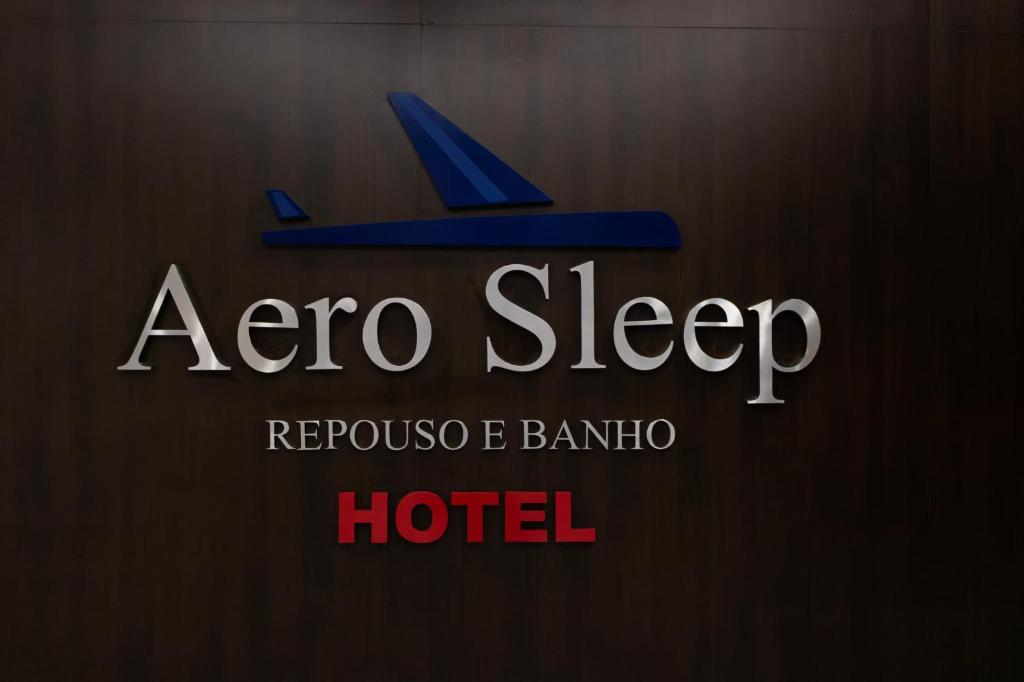 a sign for a zero sleep hotel with a plane at Hotel Aero Sleep Campinas in Campinas