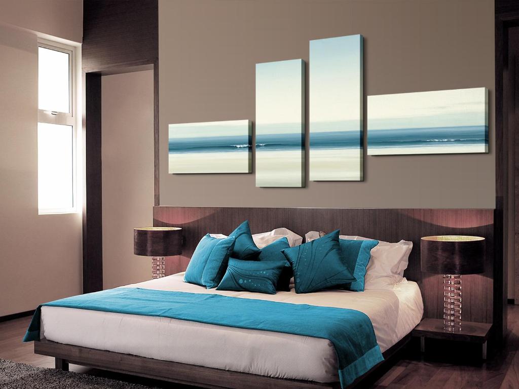 a bedroom with a large bed with blue pillows at Punta cana in El Seis