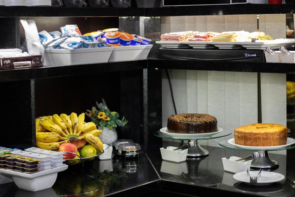 a buffet with different types of food on display at Hotel Aero Sleep Campinas in Campinas