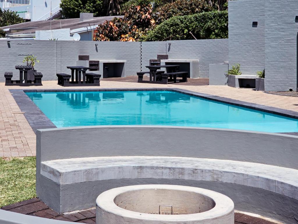 a swimming pool with a fire pit in the middle at Benka Beach, Sheffield, KwaZulu Natal in Sheffield Beach